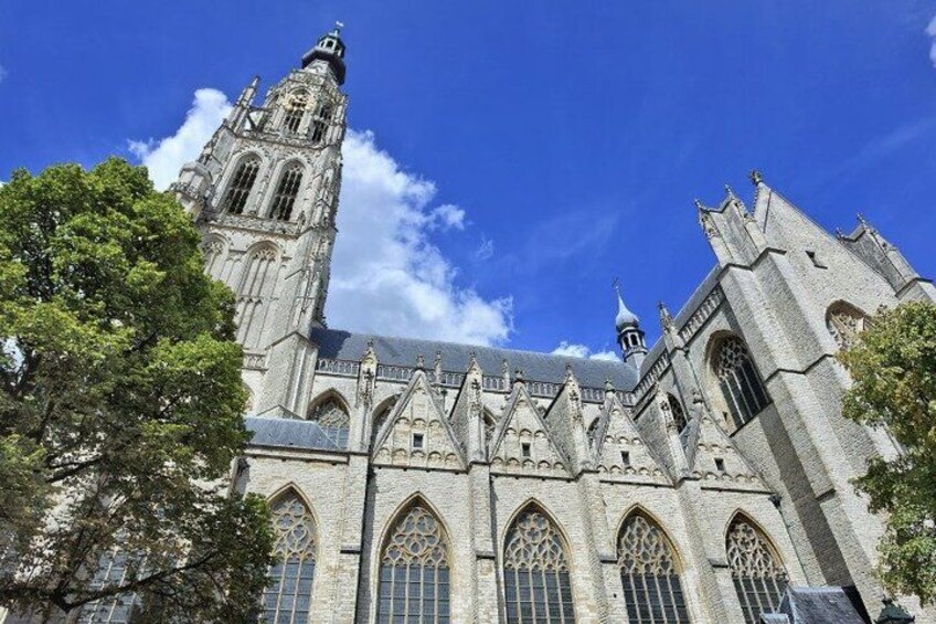 A historic cathedral with a prominent tower, large arched windows, and intricate stonework. 2