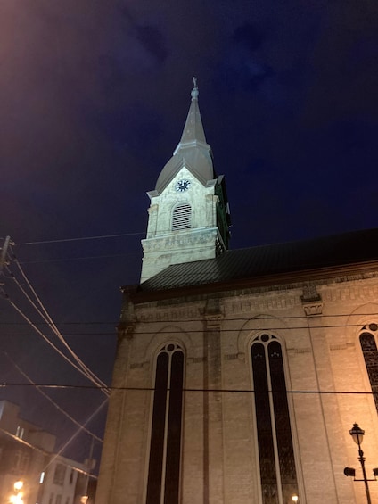 A church tower with a clock at night. 1