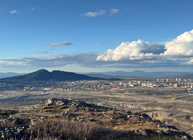 A mountainous landscape with a city in the valley. 1