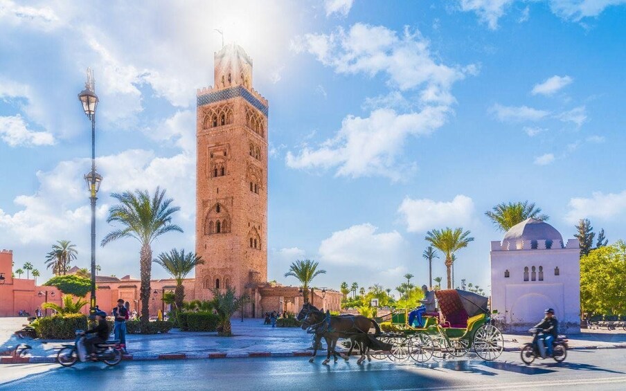 A historic tower, a horse-drawn carriage, and a mosque. 2