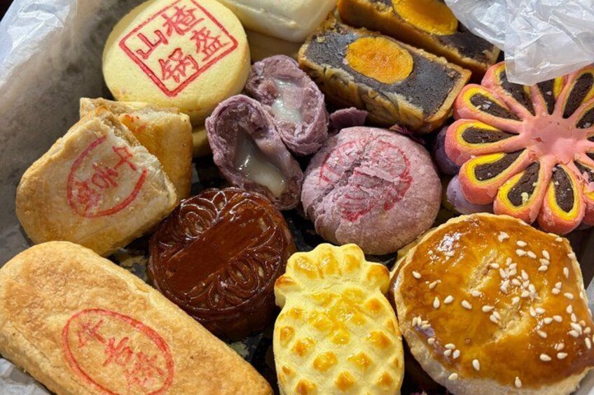 A variety of colorful pastries with visible text and patterns. 1