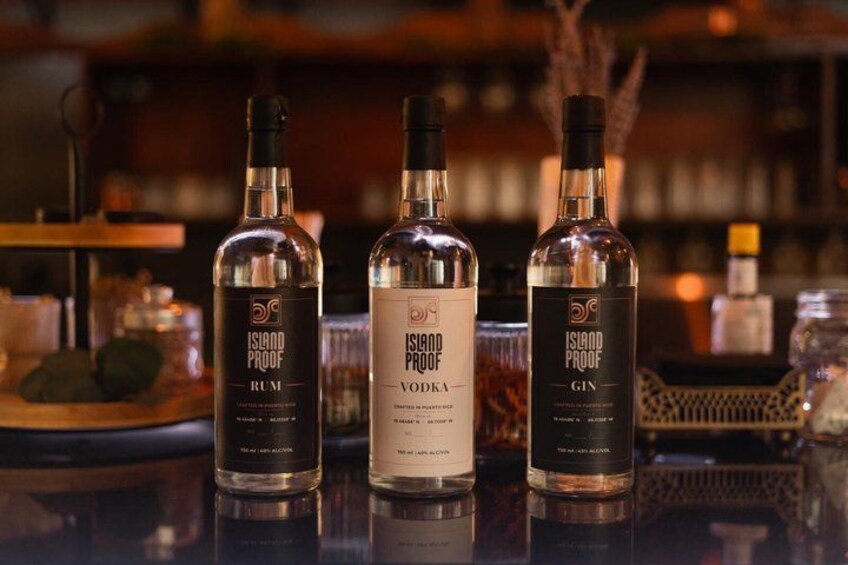Three bottles of Island Proof alcohol on a bar counter. 4