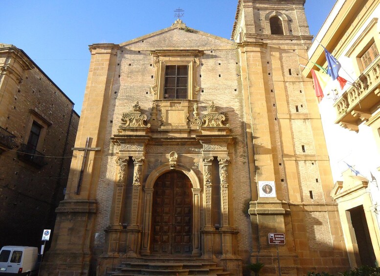 A historic building with ornate carvings and a prominent entrance. 4