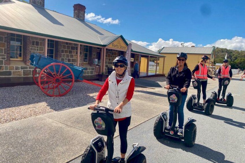 People riding segways on a paved path. 2