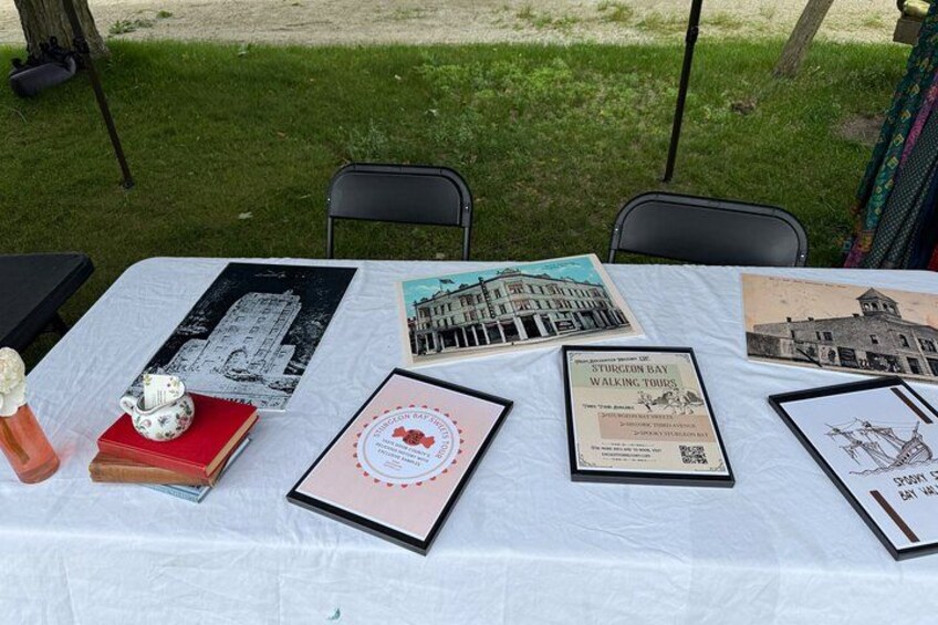A table with framed pictures and a brochure. 4