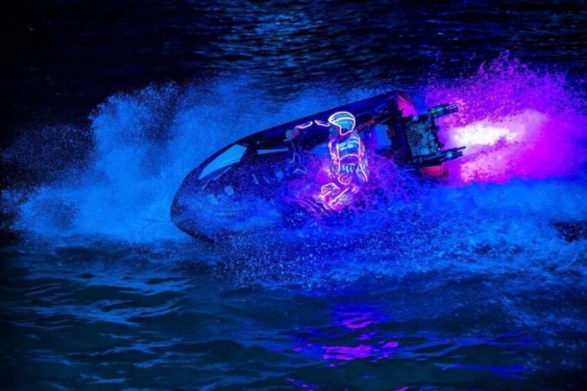 A jet ski with neon lights in the water. 4
