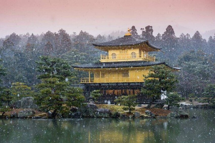 A traditional Japanese building with a tiled roof, surrounded by trees and a body of water. 3