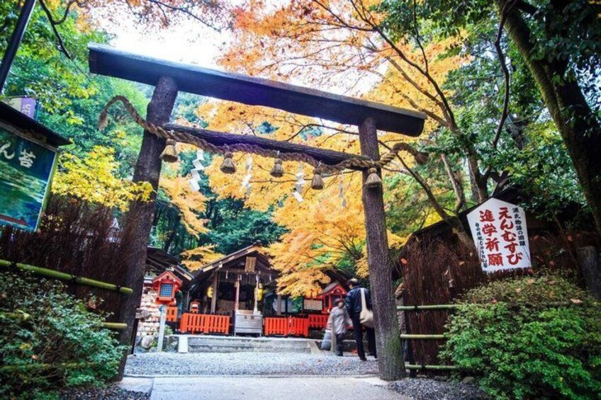A traditional Japanese torii gate, a wooden structure with a curved top, leading to a shrine. 1