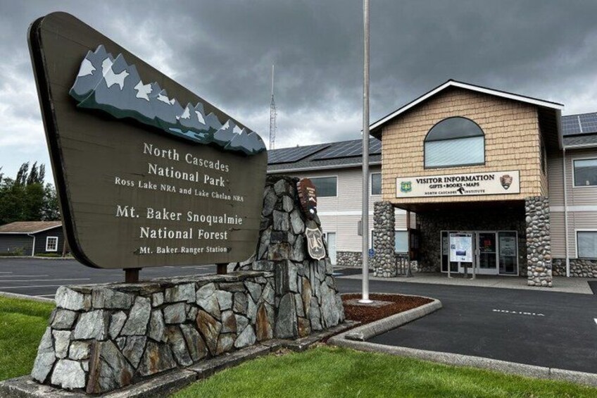 A visitor center with a sign for North Cascades National Park and Mt. Baker Snoqualmie National Forest. 4