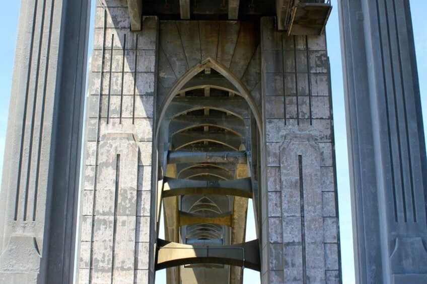 A stone archway with a series of concentric arches and a gothic design. 2