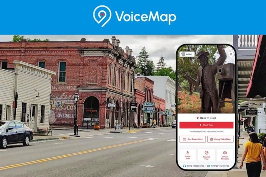 A street scene with a red brick building, a statue, and a smartphone displaying a map application. 1
