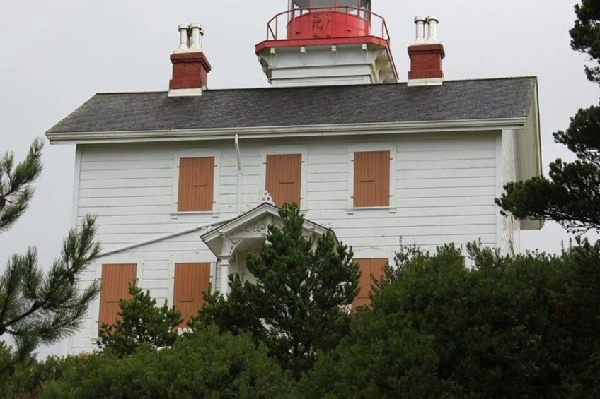 A white building with red trim and a red roof. 5