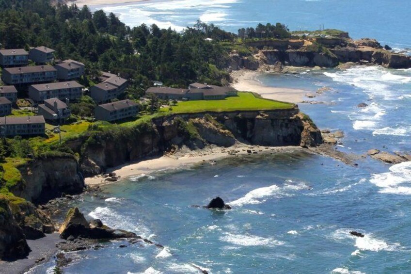 A coastal town with houses, cliffs, and a beach. 3