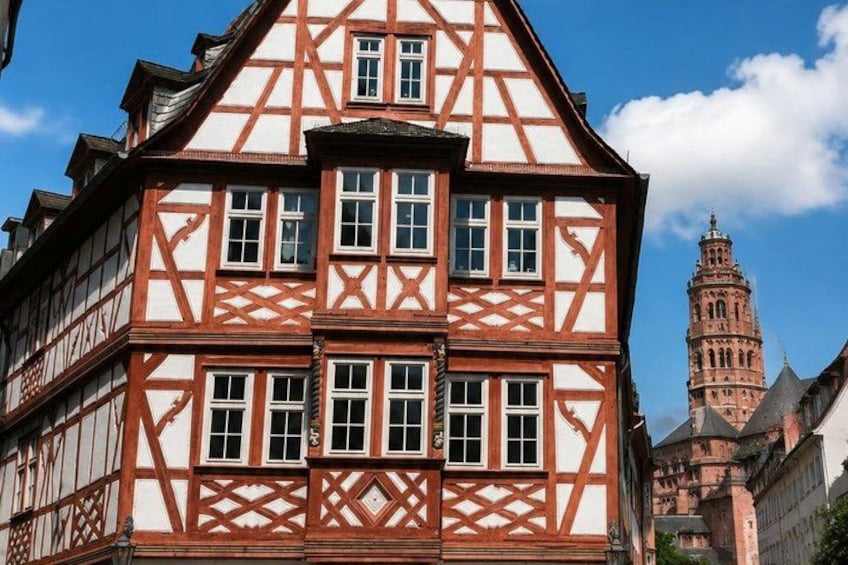 A half-timbered building with a prominent tower in the background. 4