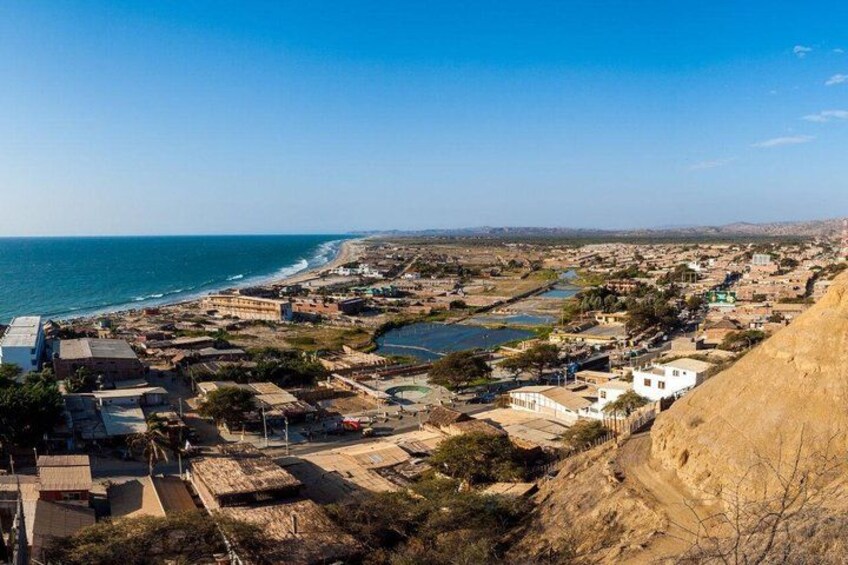 A coastal town with buildings, a beach, and a river. 4