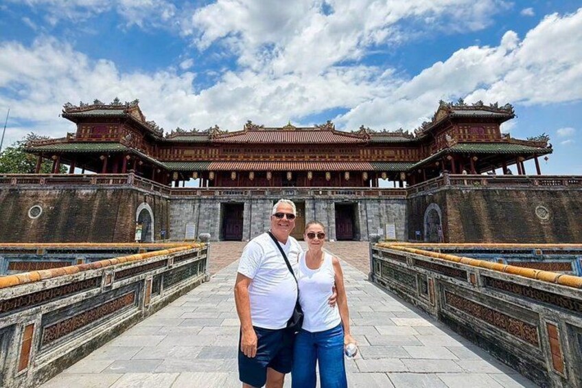 A historic building with traditional architecture, a paved walkway, and a clear sky. 5