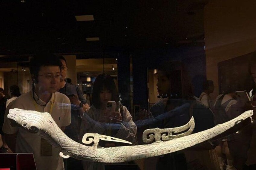 A large snake sculpture displayed in a museum. 2
