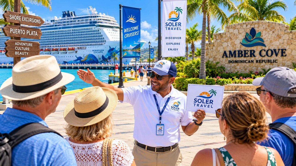 A cruise ship docked at a port with a sign for Amber Cove and a person holding a sign for Soler Travel. 2