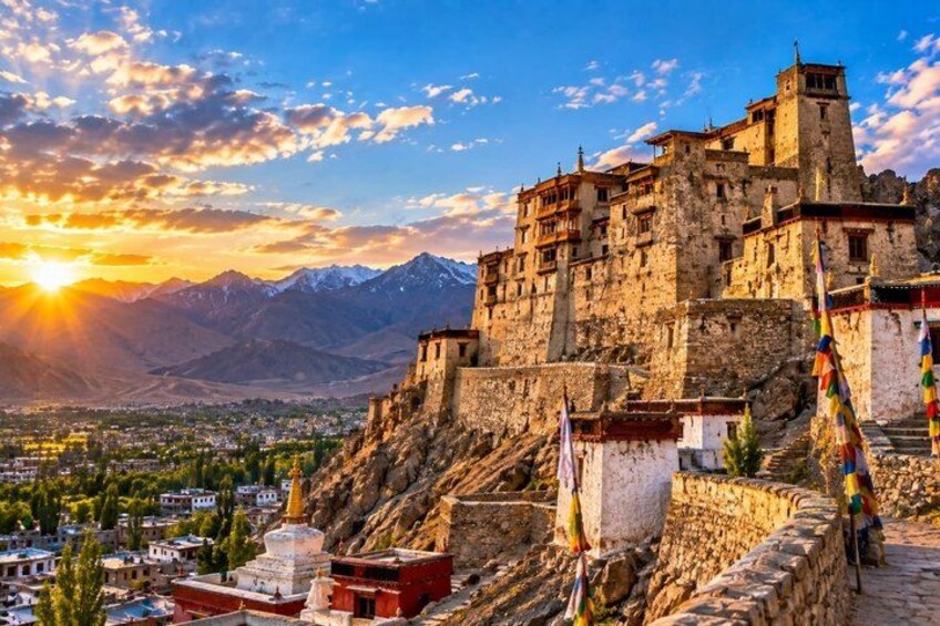 A historic fortress with a view of a valley and mountains in the background. 4