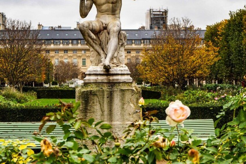 A statue in a park with a building in the background. 5