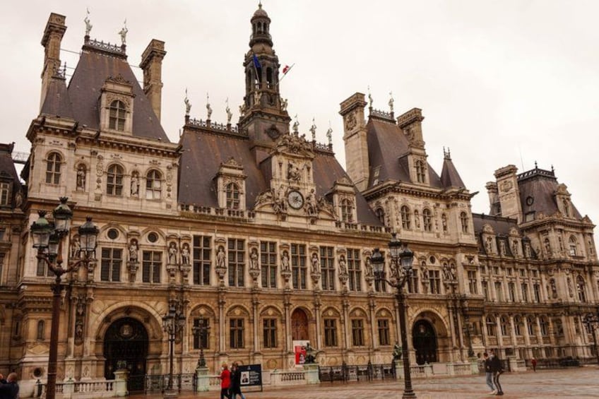 A historic building with ornate architecture, including multiple chimneys and statues. 3