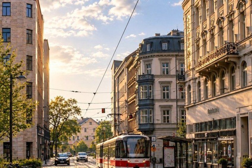 A tram, buildings, and a street with cars. 3
