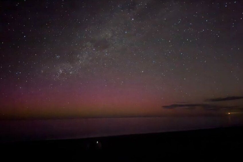 A night sky filled with stars and the Milky Way over a calm body of water. 2