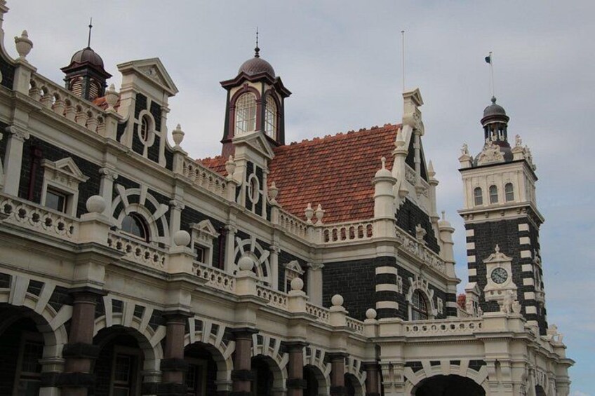 A historic building with ornate architectural details, including domes and a clock tower. 4