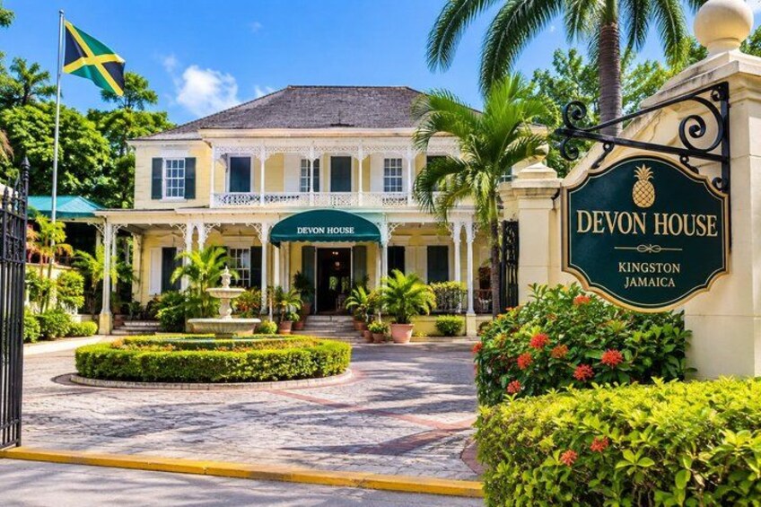 A historic building with a sign reading 'Devon House' and 'Kingston Jamaica.' 2