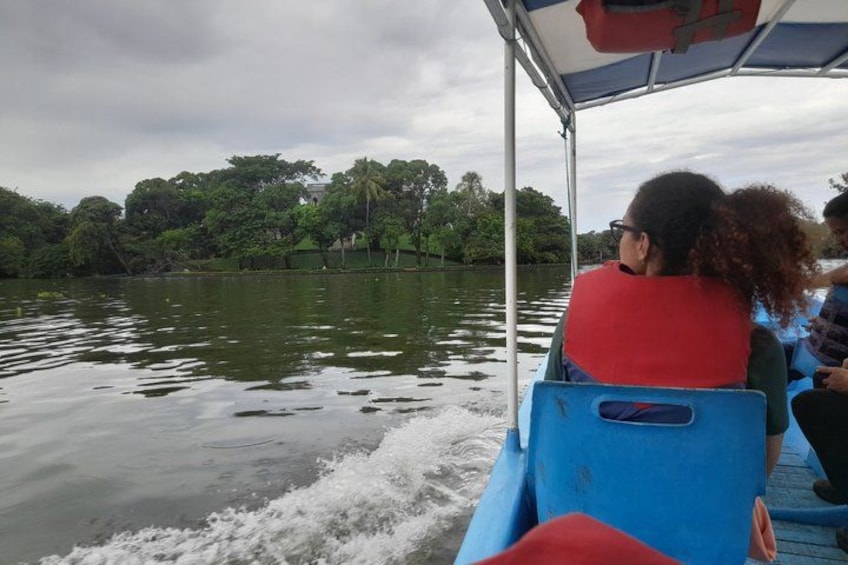 A boat on a river with passengers wearing life jackets. 3