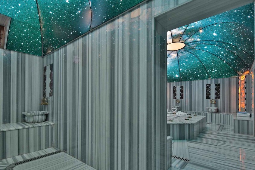 A modern interior with a starry ceiling, striped walls, and a central table with a unique light fixture. 5