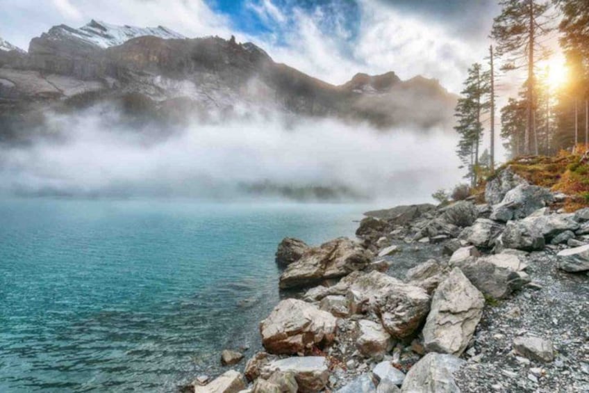 A lake surrounded by rocky terrain and mountains. 4
