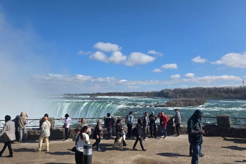 A group of people observing a waterfall. 3