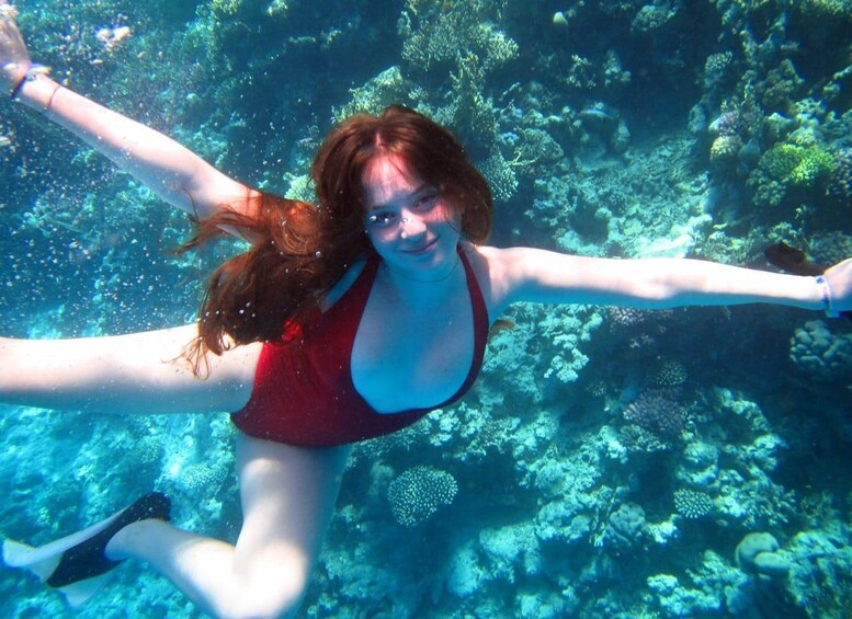 Una persona sott'acqua con una barriera corallina sullo sfondo. 2