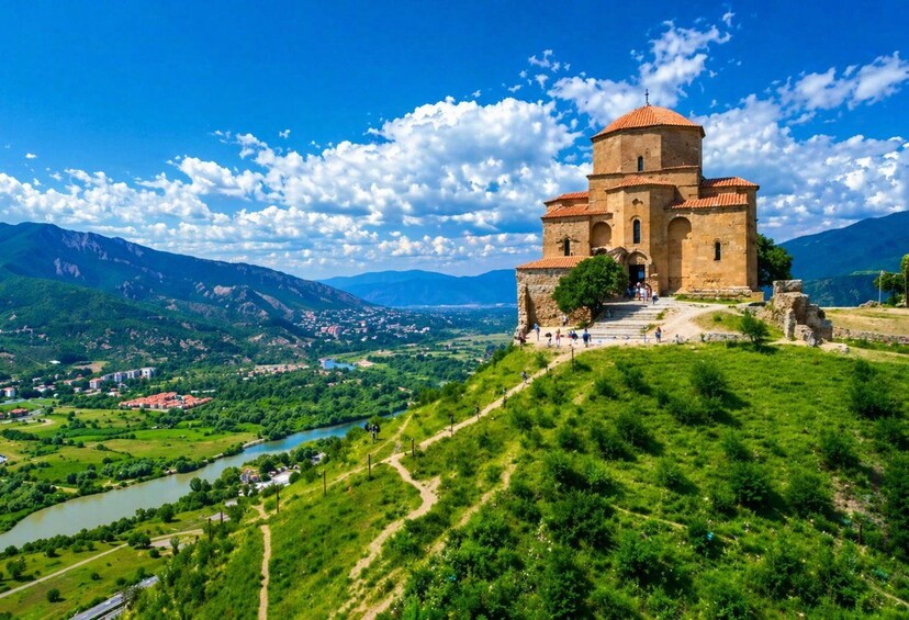 Eine historische Kirche auf einem Hügel mit Blick auf einen Fluss und ein Tal. 1