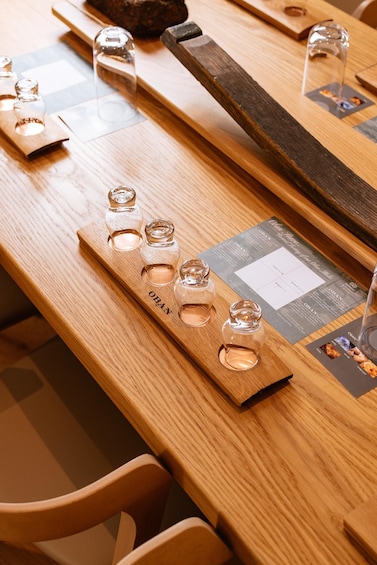 A wooden table with glass bottles labeled 'OBAN' and a menu. 5