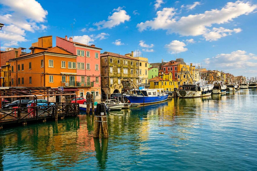A waterfront with colorful buildings and boats docked along the canal. 3