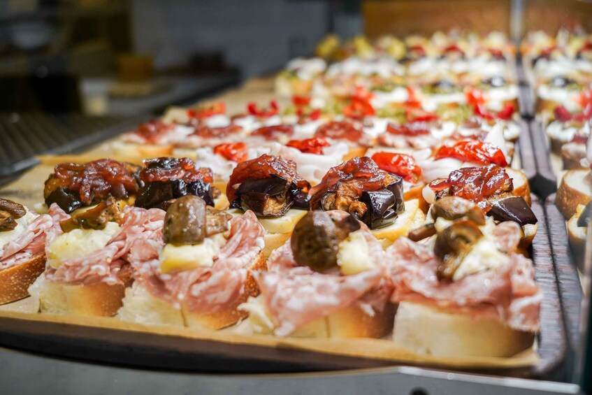 A variety of appetizers on a tray, including items with meats, cheeses, and vegetables. 4