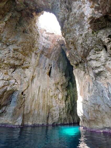 A natural rock formation with a water body at its base. 4