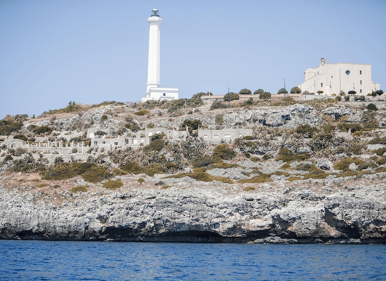 A coastal landscape with a lighthouse, a church, and rocky terrain. 5