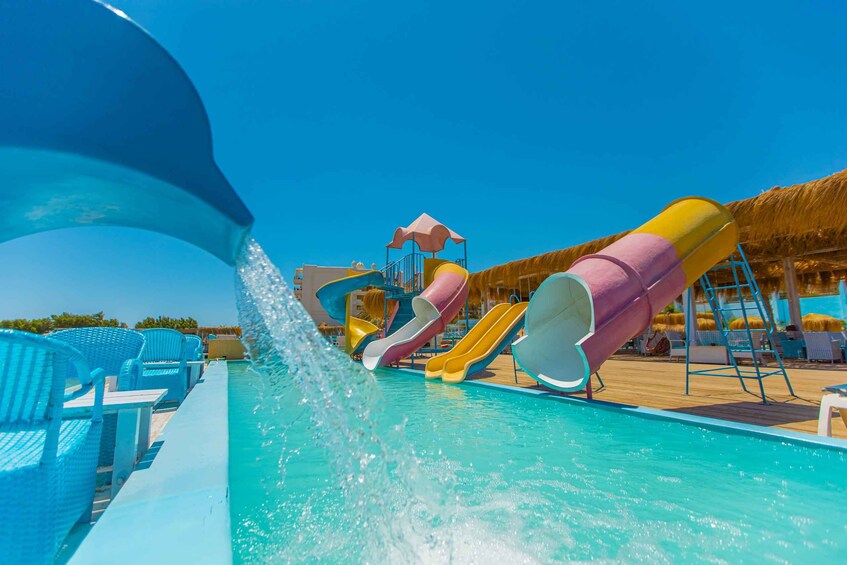 A water park with multiple slides and a pool. 4