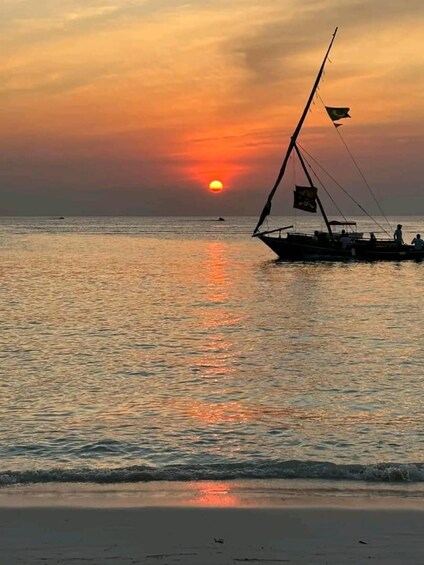 A boat with sails on a calm sea during sunset. 3