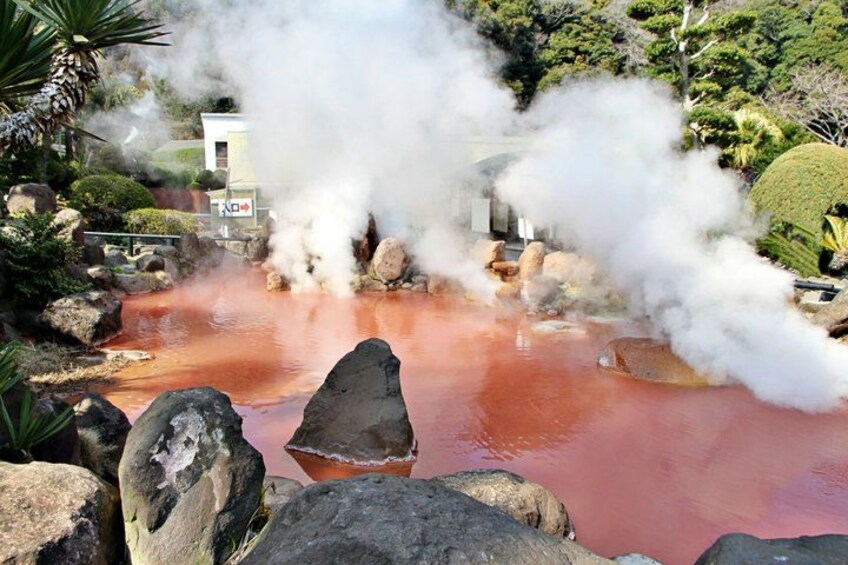 A geothermal area with steam, red-hot water, and rocks. 3