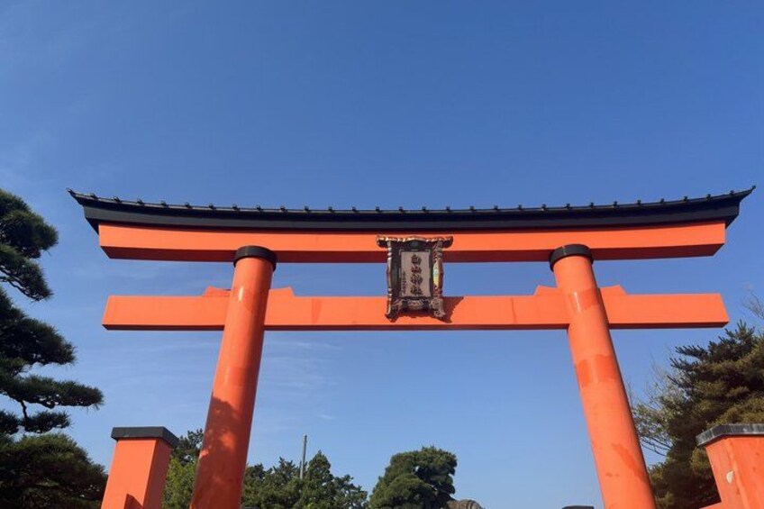 A traditional Japanese torii gate with a red frame and black roof. 4