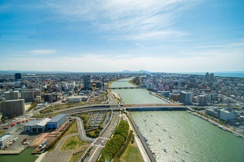 A cityscape with a river, bridges, and a highway. 1