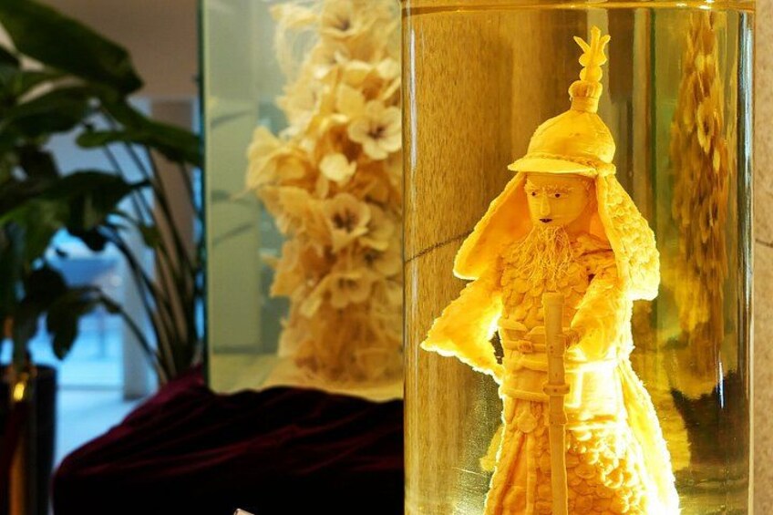 A golden statue in a glass display case. 2