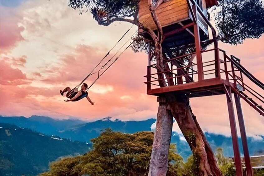 A person swinging on a rope from a treehouse. 2