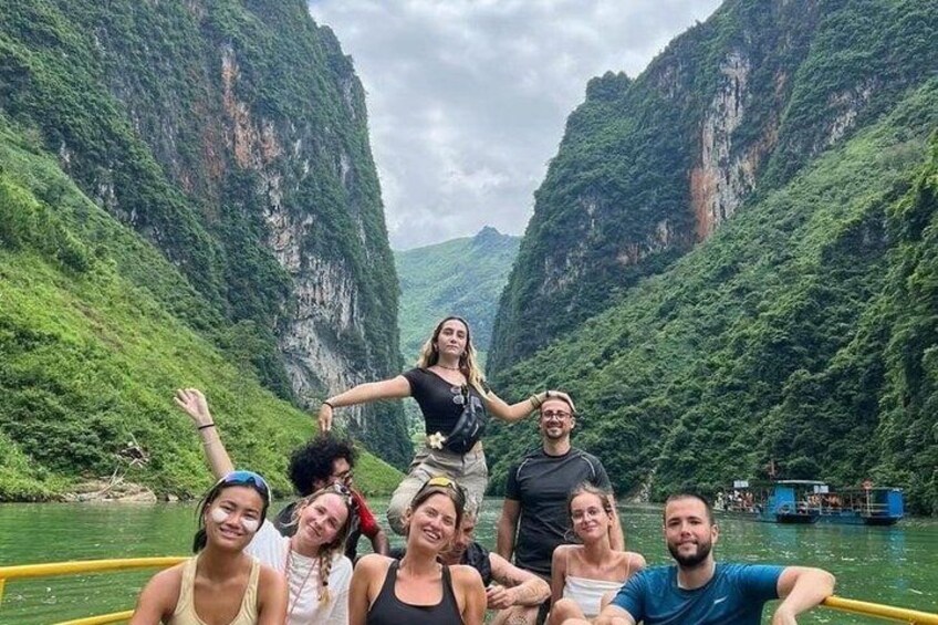 A group of people on a boat in a river canyon with steep cliffs. 2