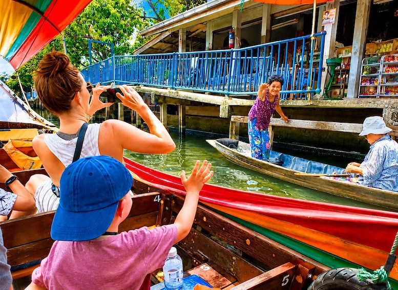 A group of people on a boat, a dock, and a building with a sign. 1