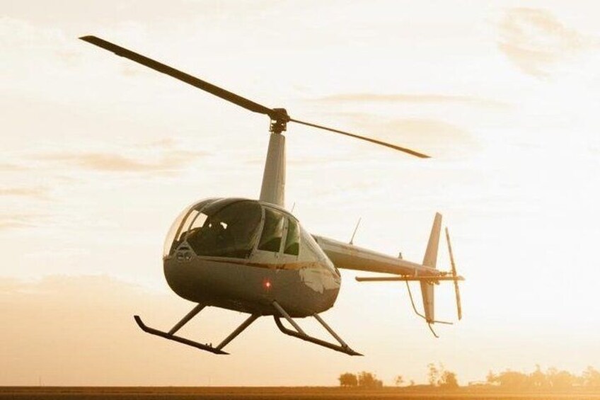 A helicopter in flight with a clear sky in the background. 5
